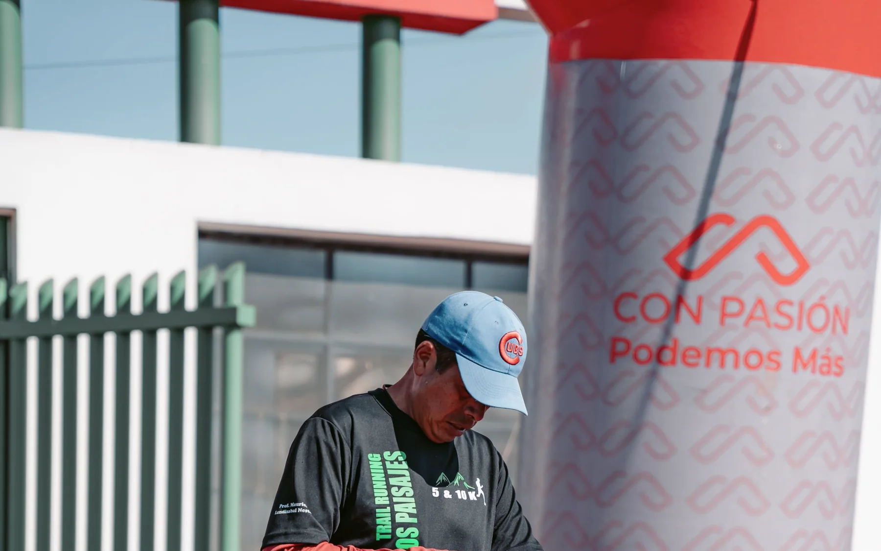 A runner checking his watch after crossing a timing point